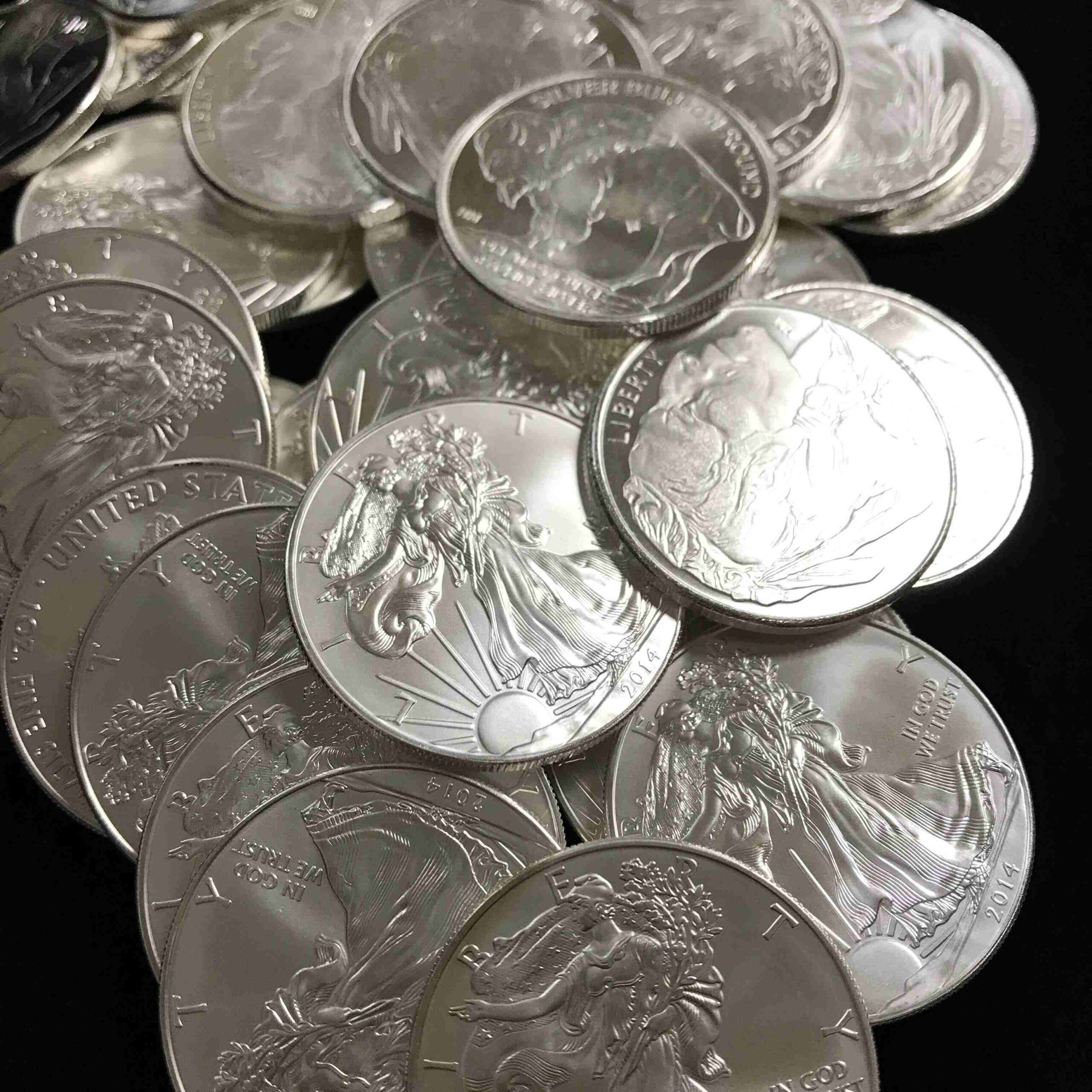 A pile of silver coins sitting on top of each other.